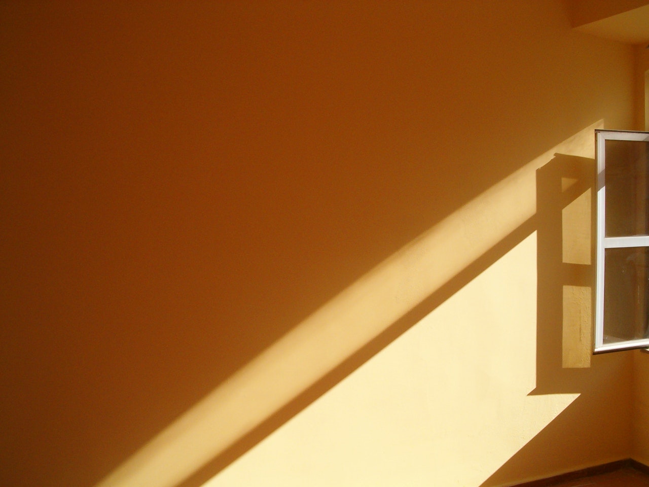 a window and orange wall